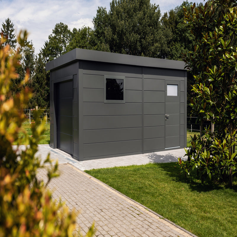 Telluria Sustainable Eleganto Garage in Anthracite. Outside view showing the front, right of garage in situ with front garage door, side entry and window,  giving good idea of size, look and feel.