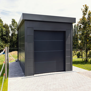 Telluria Sustainable Eleganto Garage in Anthracite. Outside front view of garage in situ, showing front with garage door and left side with drain pipe at the back.