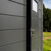 Telluria Sustainable Eleganto Garage in Anthracite. Close up of side door  slightly open, showing locking mechanism, garage panels and door window.