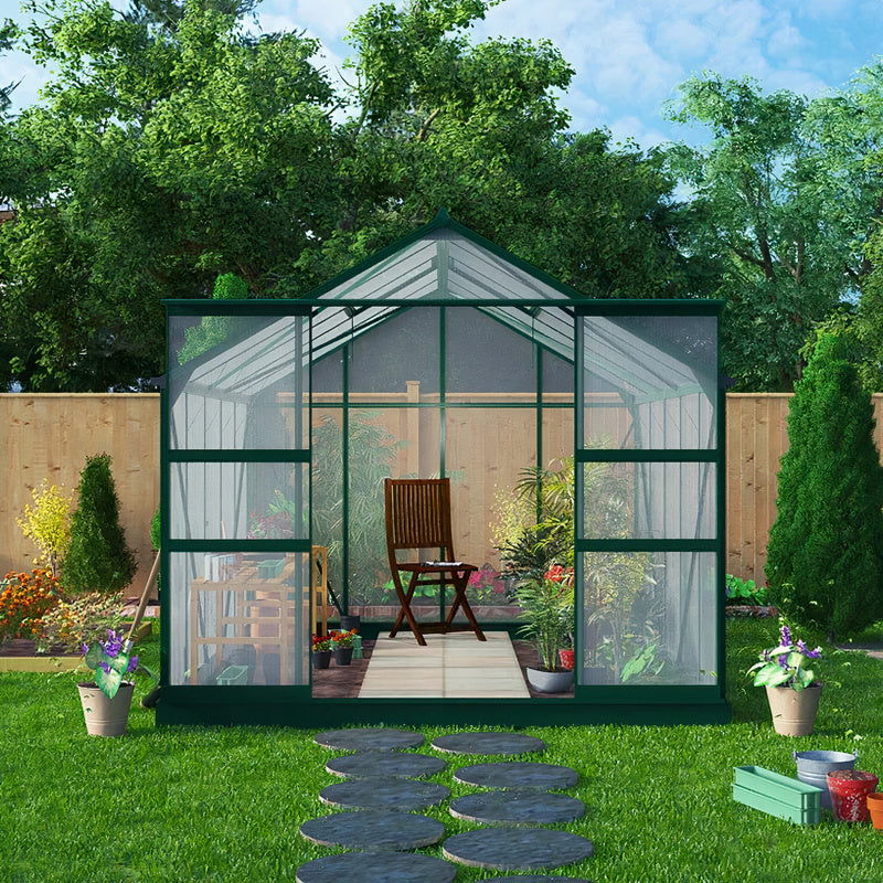 Harvester Polycarbonate, Extra-Tall Walk in Greenhouse. Front outside view showing double sliding doors open on the front and the apex roof, giving a good view of space inside. Set in a garden.