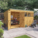 Customisable Pent Tongue & Groove Wooden Shed outside front left view with double doors and windows on front. Open with equipment, set in a garden. 12x8