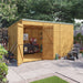 Customisable Pent Tongue & Groove Wooden Shed outside front left view, windowless  with double doors on front. Open with equipment, set in a garden. 12x8