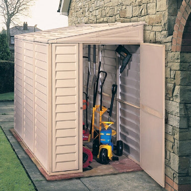 Saffron Lean-To Vinyl Shed with Foundation Kit, Mounted to a house on the right, front door open to show inside storage capabilities.